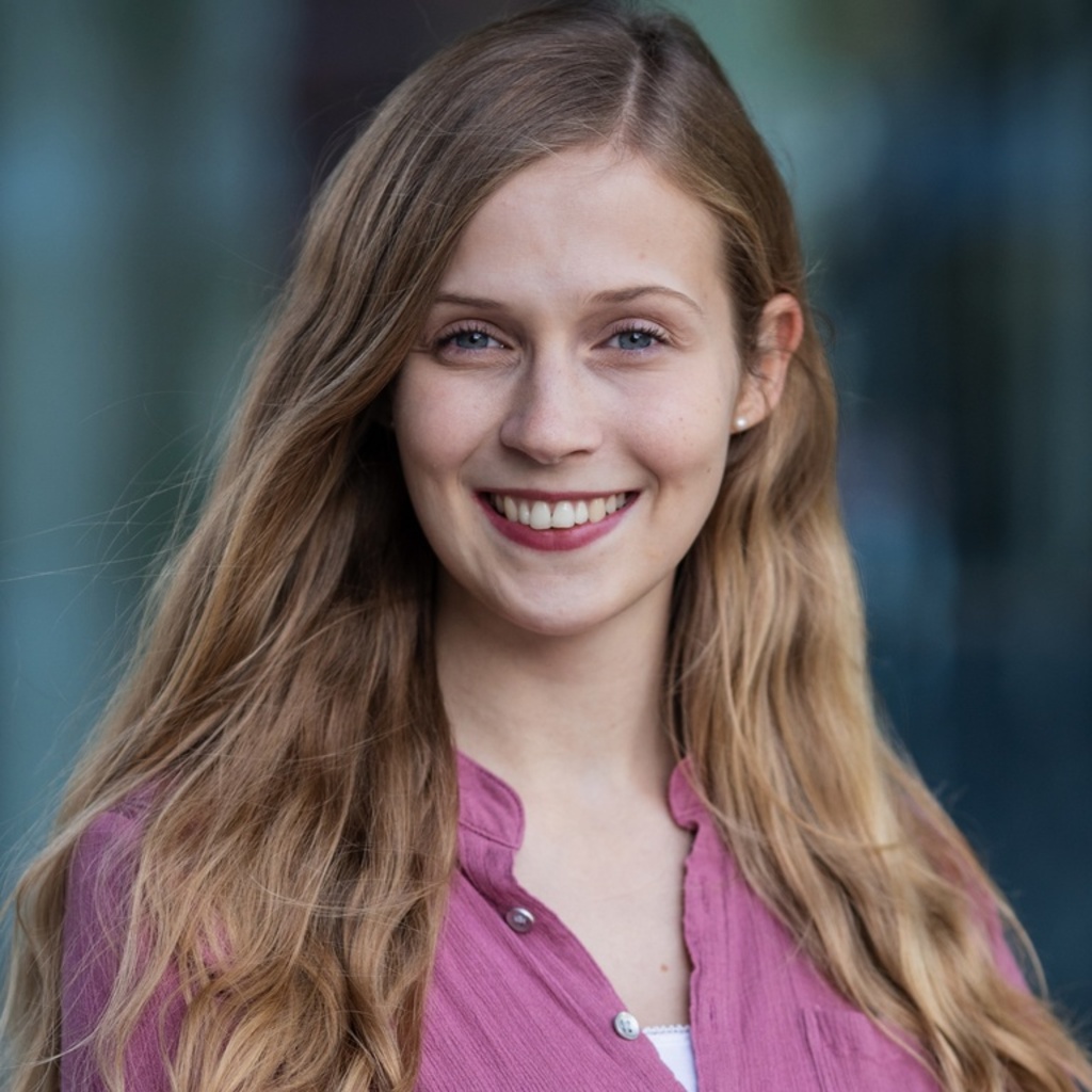 woman with long blond hair in a pink shirt