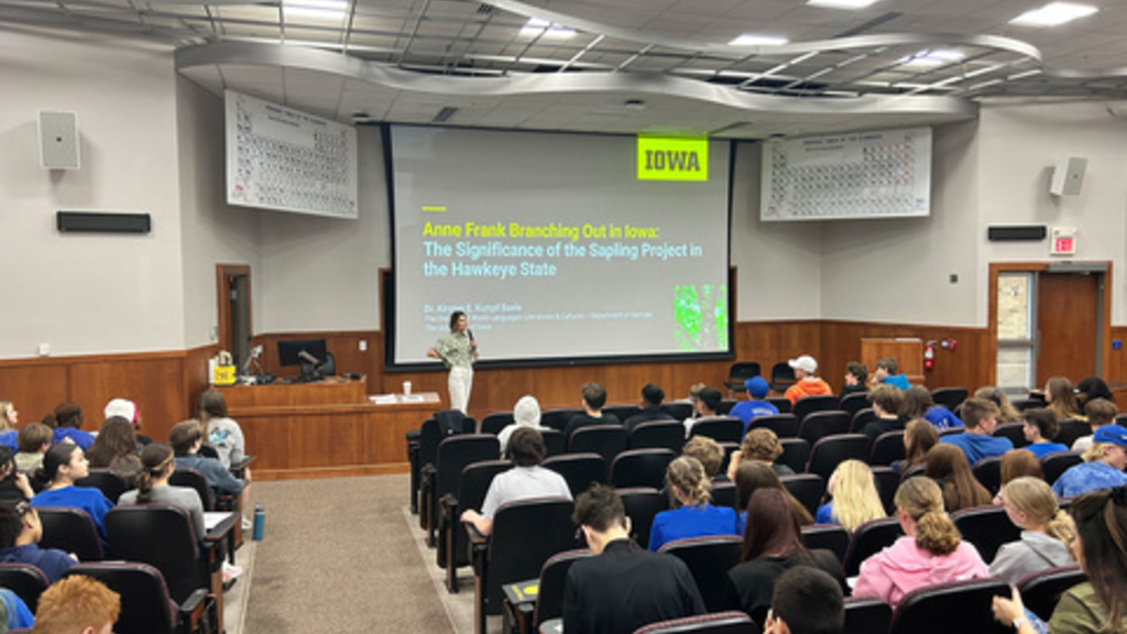 Kirsten Kumpf Baele speaking in front of the group of Clear Creek Amana students